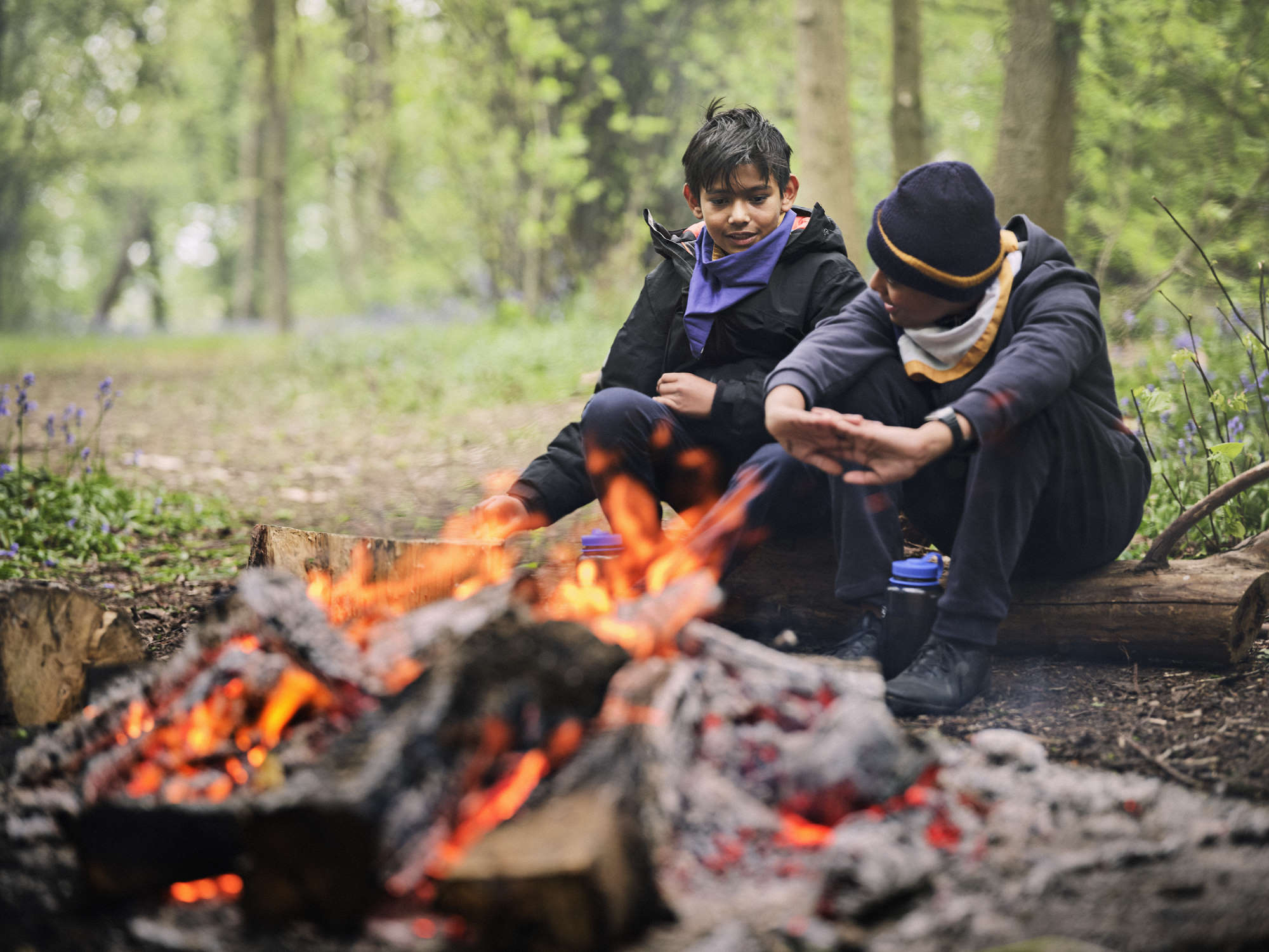 Photo: Two Scouts by a campfire.